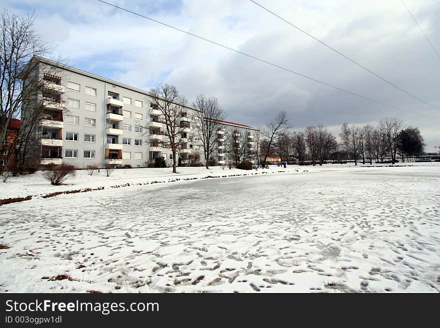 Residential area in Winter.A frozen lagoon in frongt of apartments. Residential area in Winter.A frozen lagoon in frongt of apartments.