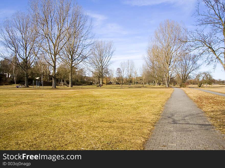 A park in weekend with people playing aroud.