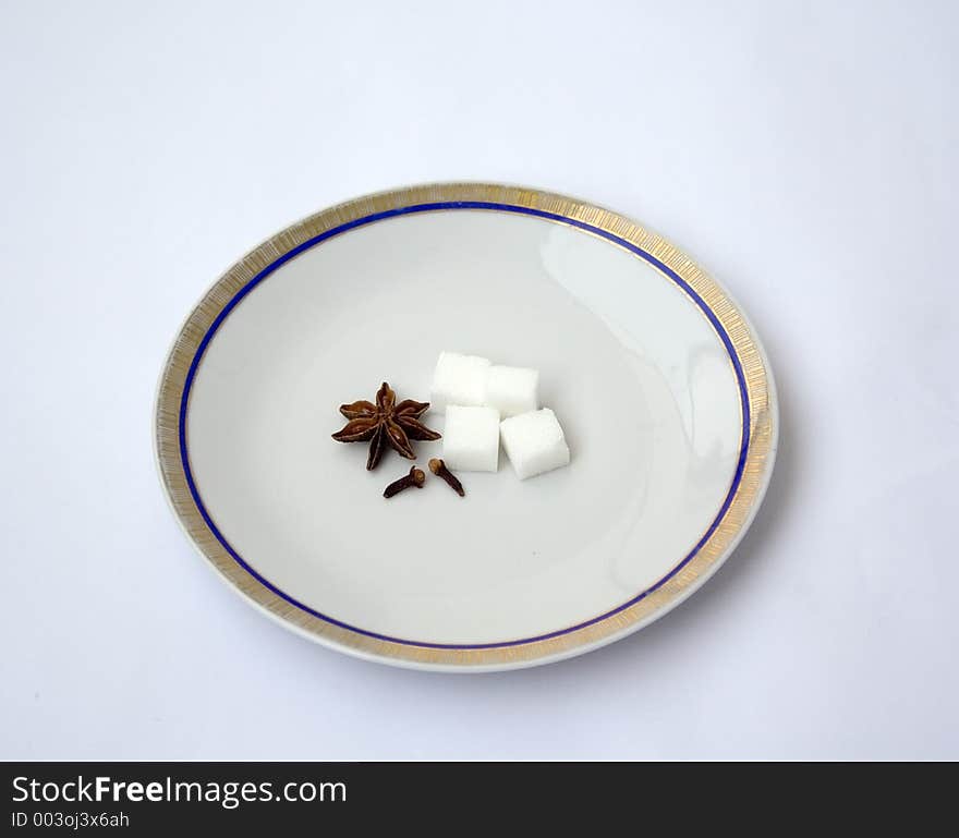 A partially filled plate with spice and sugar - Isolated. A partially filled plate with spice and sugar - Isolated