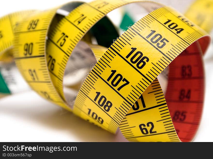 Winding tape measure against white. Winding tape measure against white.