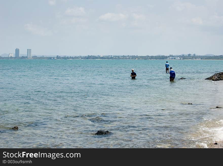 Three People Fishing, Pataya City on the horizon Location: Pataya, Thailand