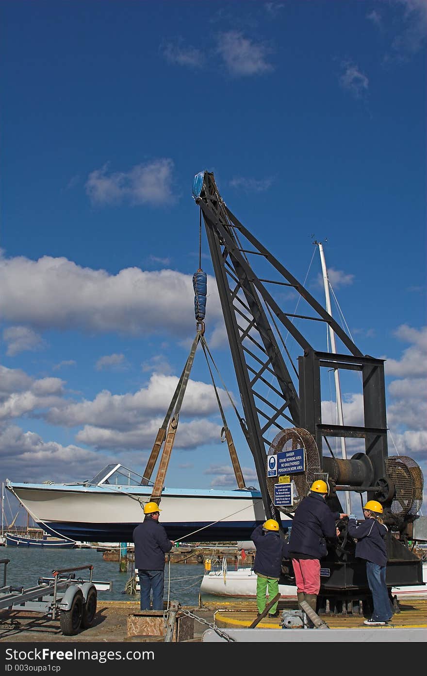 People Putting Boat Into Water