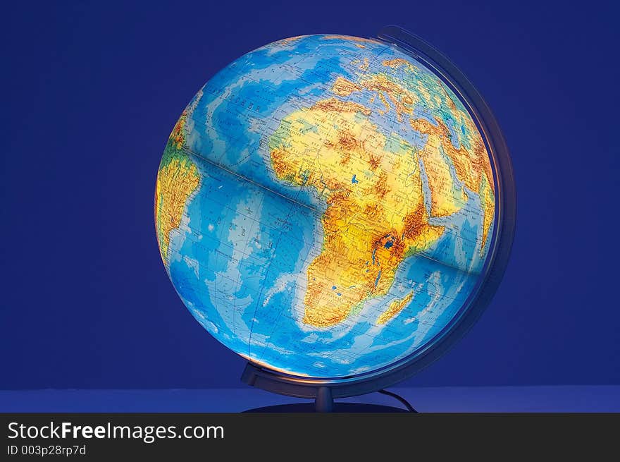 Shining globe showing africa on blue background. Shining globe showing africa on blue background