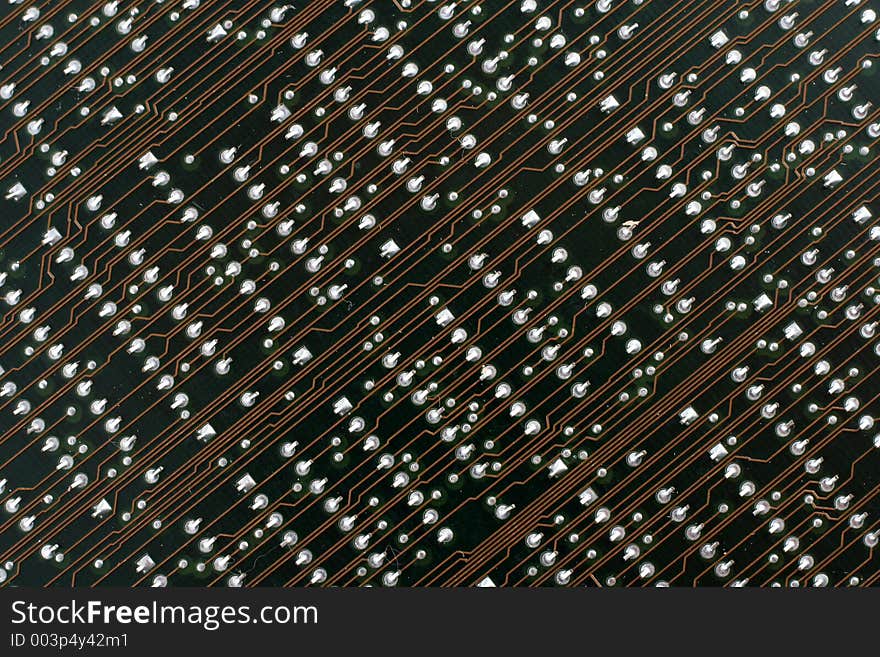 Back side of an old circuit board from an obsolete computer interface.