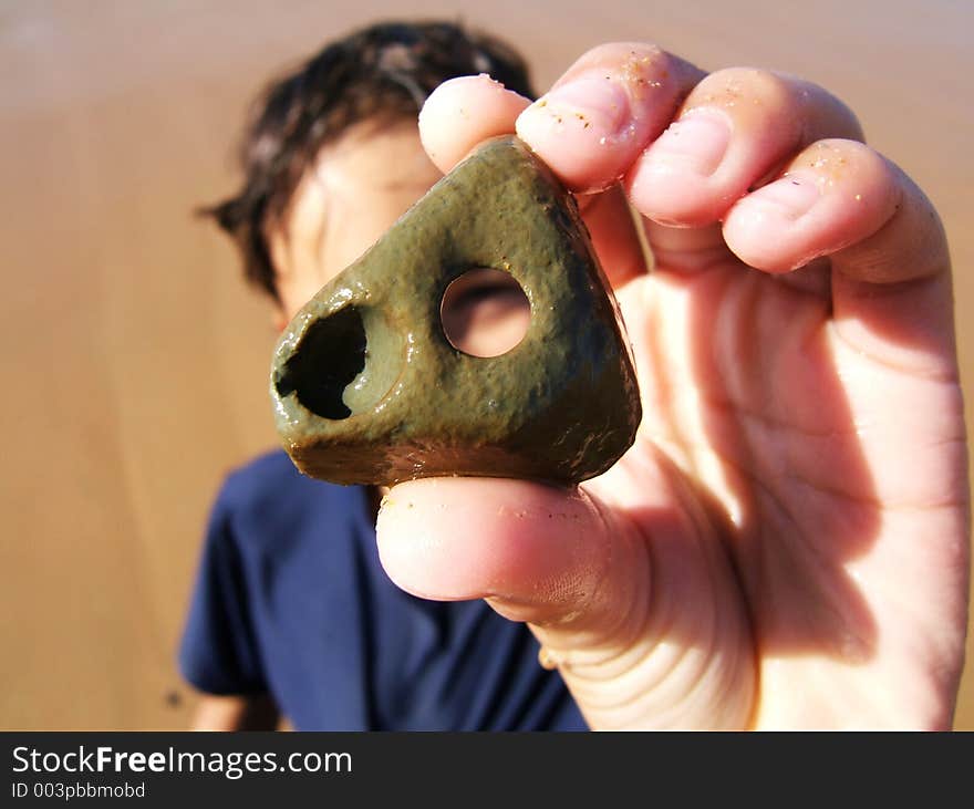 Boy looking through a whole in a rock. Boy looking through a whole in a rock