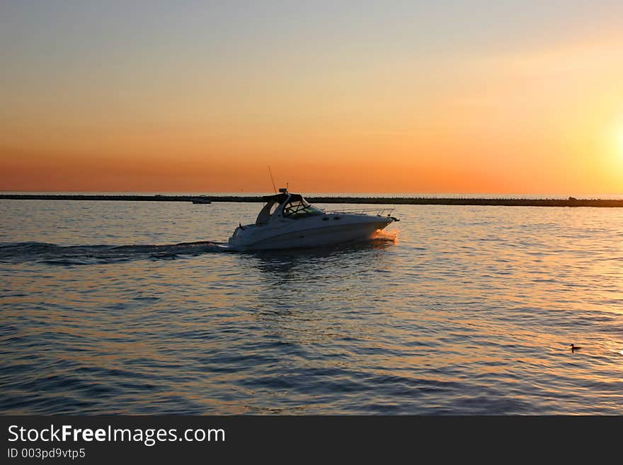 Motorboat at sunset, captured at Michigan City. Motorboat at sunset, captured at Michigan City.