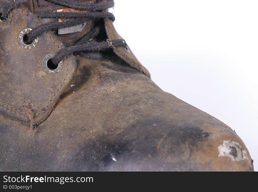 A well worn close up of a work boot. A well worn close up of a work boot.