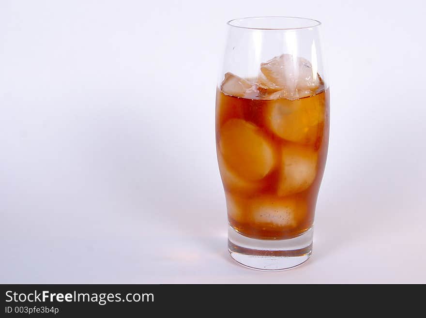 An isolated view of a glass of ice tea on ice. An isolated view of a glass of ice tea on ice.