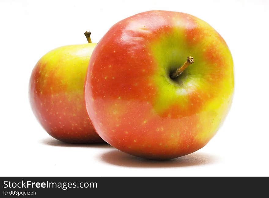 Two colorful shiny fruits on a white background. Two colorful shiny fruits on a white background.