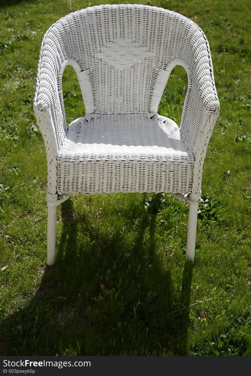 White garden chair in a grass floor