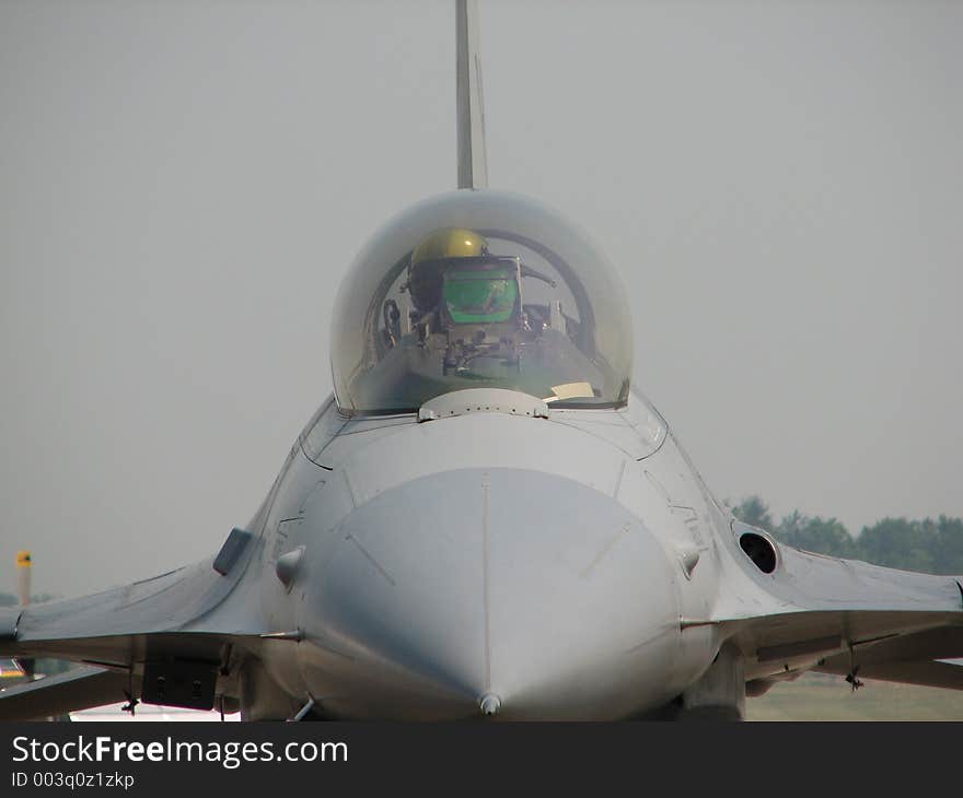 Pilot inside the cockpit of a fighter jet.