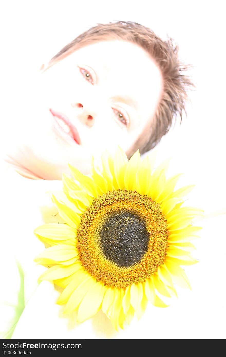 Close up of a woman's face and a sunflower. Close up of a woman's face and a sunflower