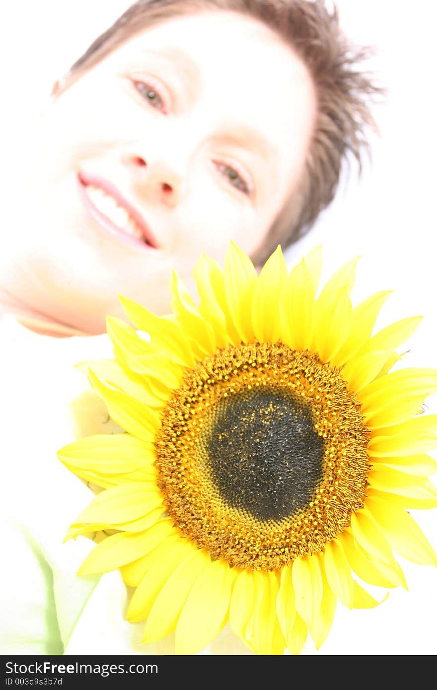 Close up of a woman's face and a sunflower. Close up of a woman's face and a sunflower