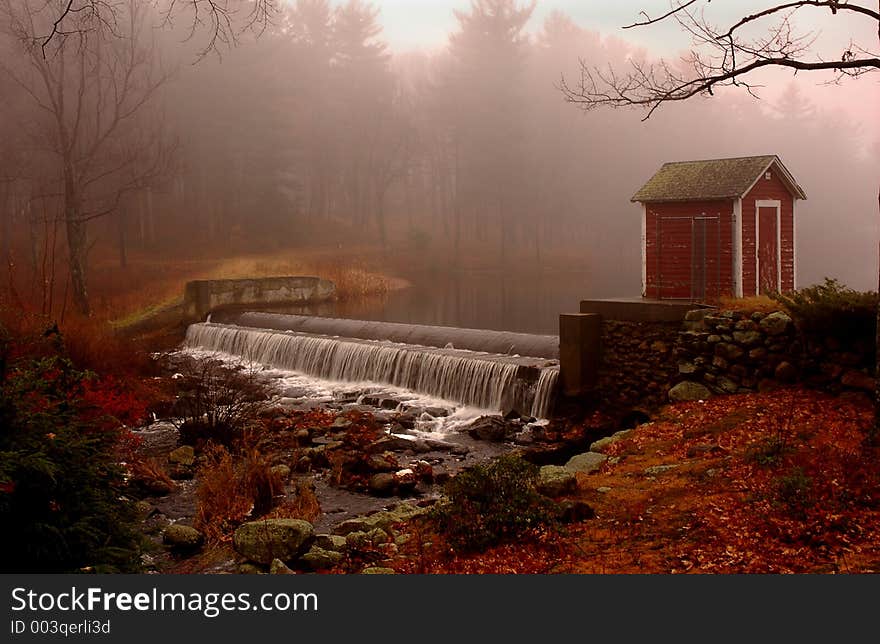 Water over the dam in the fog. Water over the dam in the fog