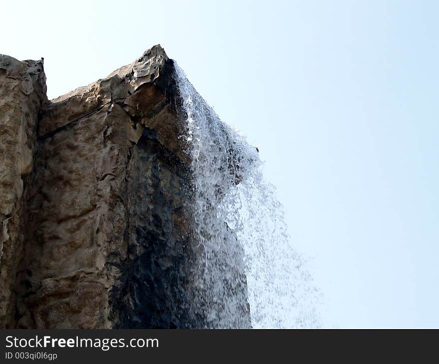 An artificial waterfall, day view.