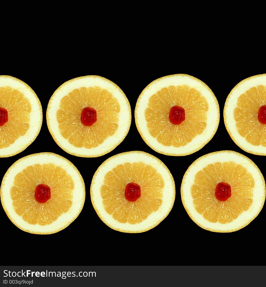 Design of seven grapefruit halves with red cherries at their centres isolated against a black background. Design of seven grapefruit halves with red cherries at their centres isolated against a black background.