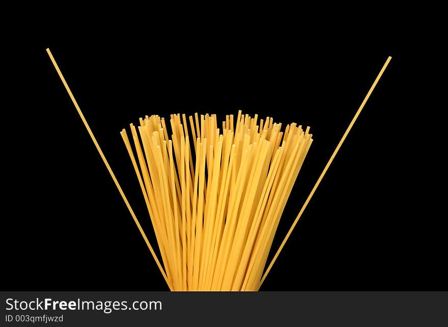 Spaghetti against a black background.