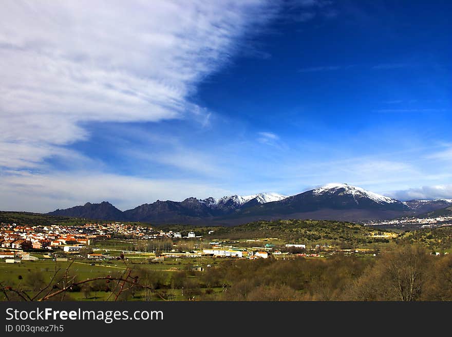 Mountains, Village And A Blue Sky