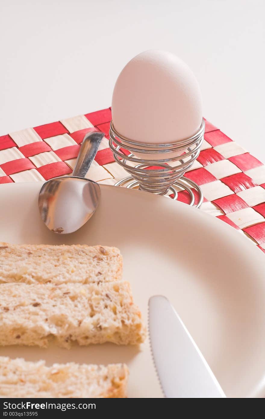 Egg and bread in plate over white. Egg and bread in plate over white