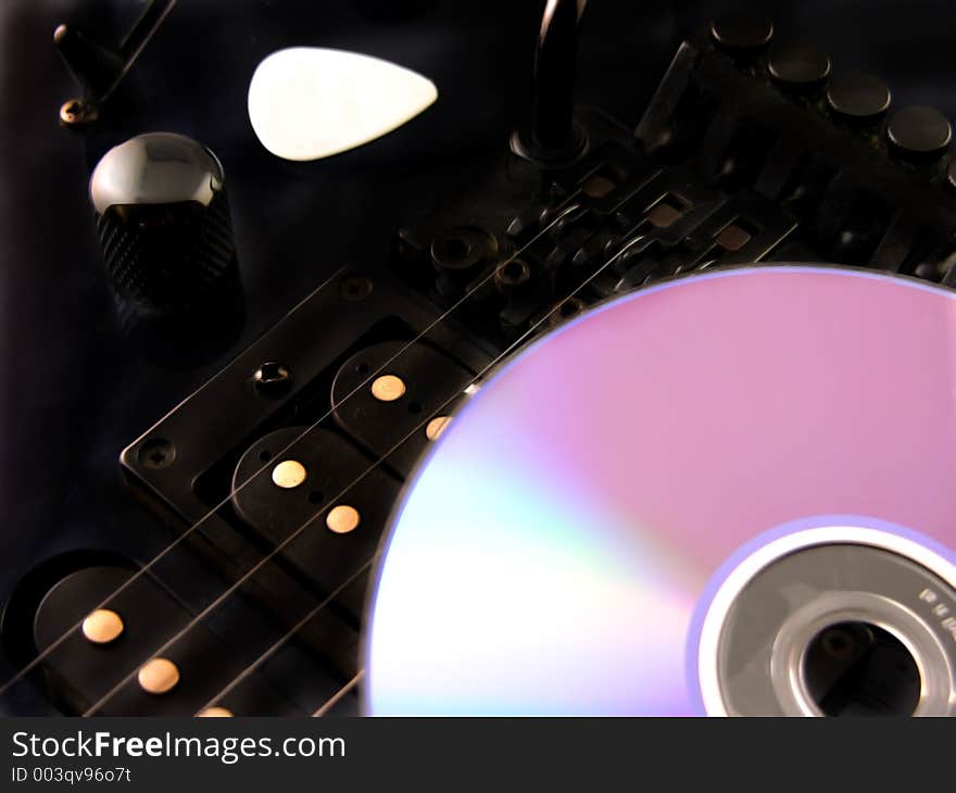 Making Music - Electric guitar compact disc and guitar pick. Making Music - Electric guitar compact disc and guitar pick