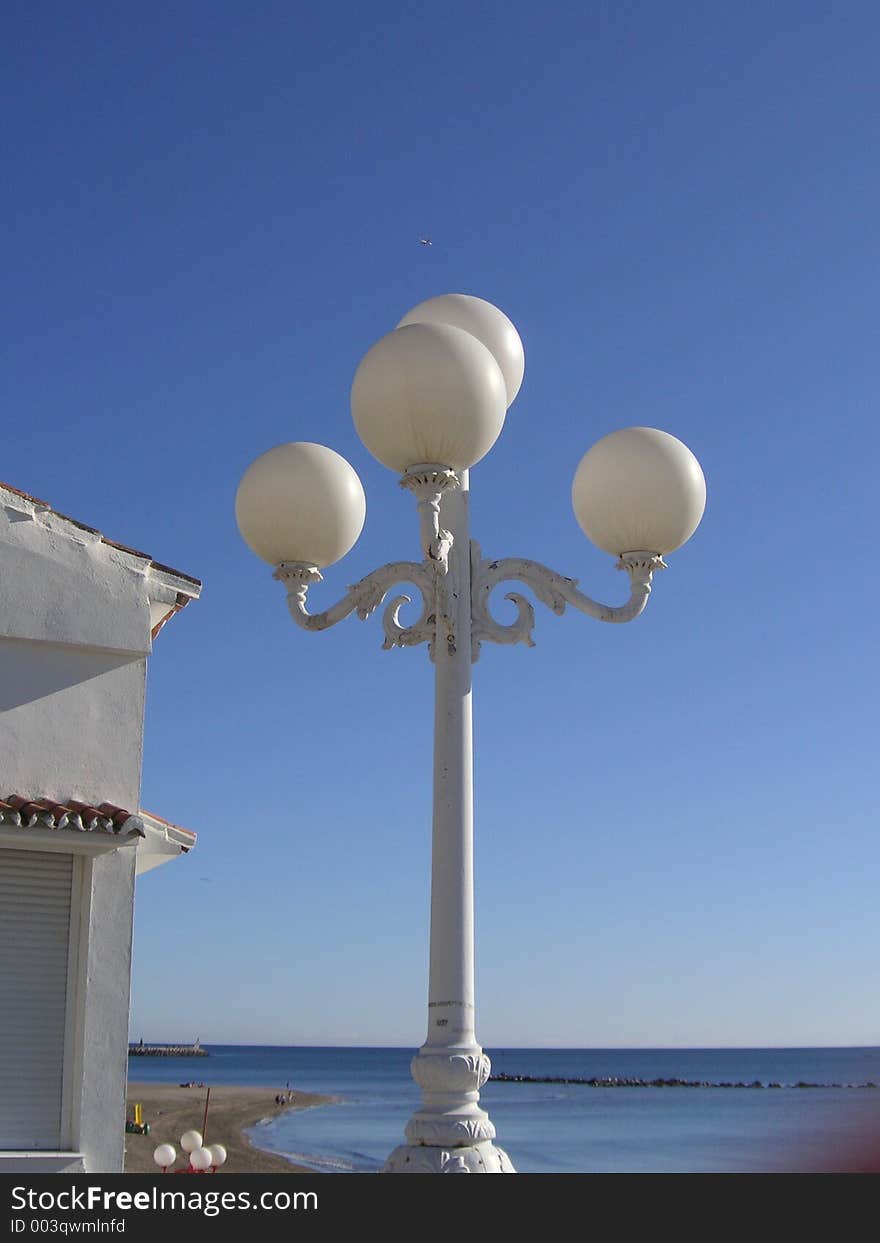 Globe street lighting against a blue sky