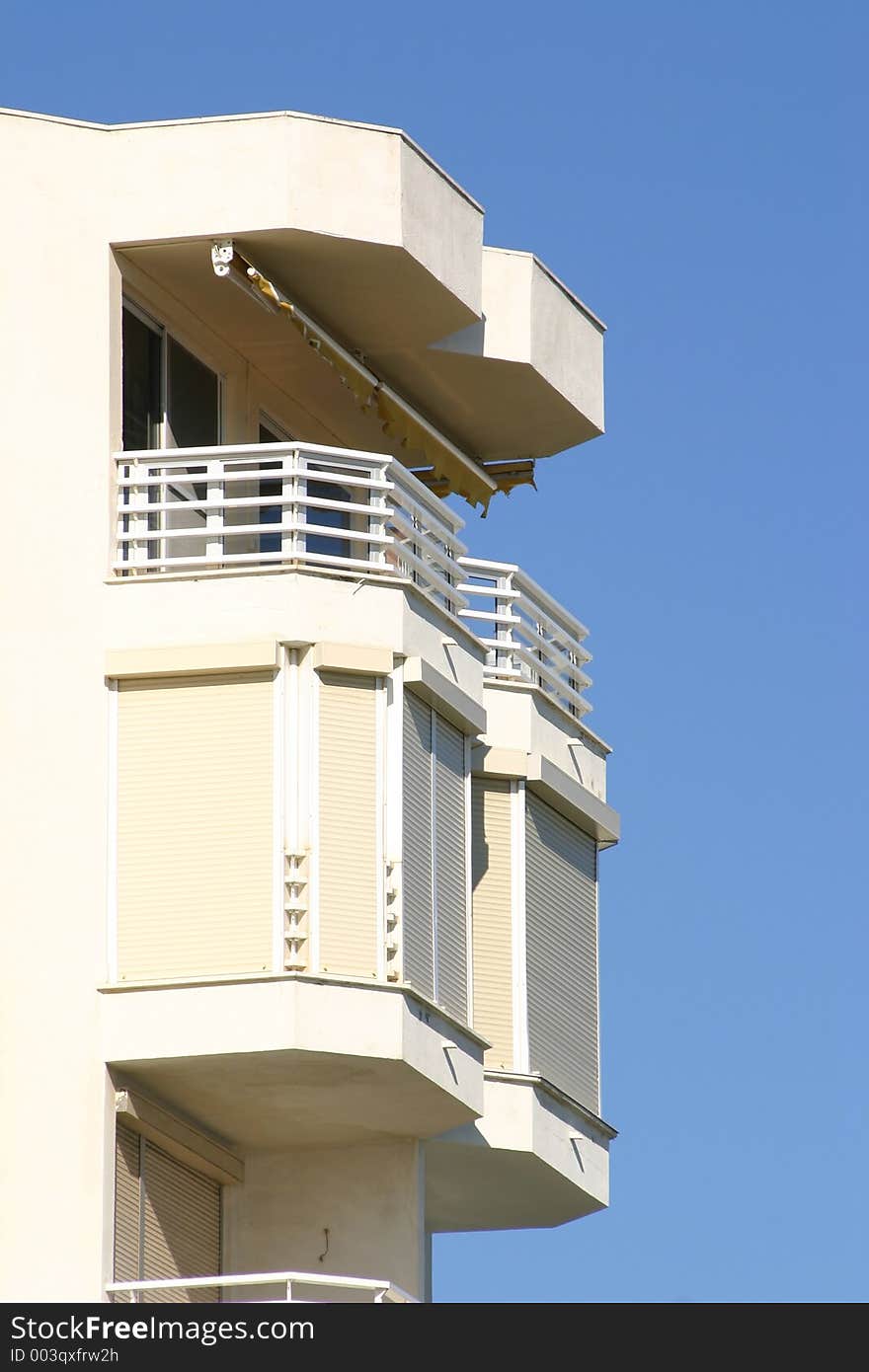 Balcony of a top floor apartment against a blue sky. Balcony of a top floor apartment against a blue sky