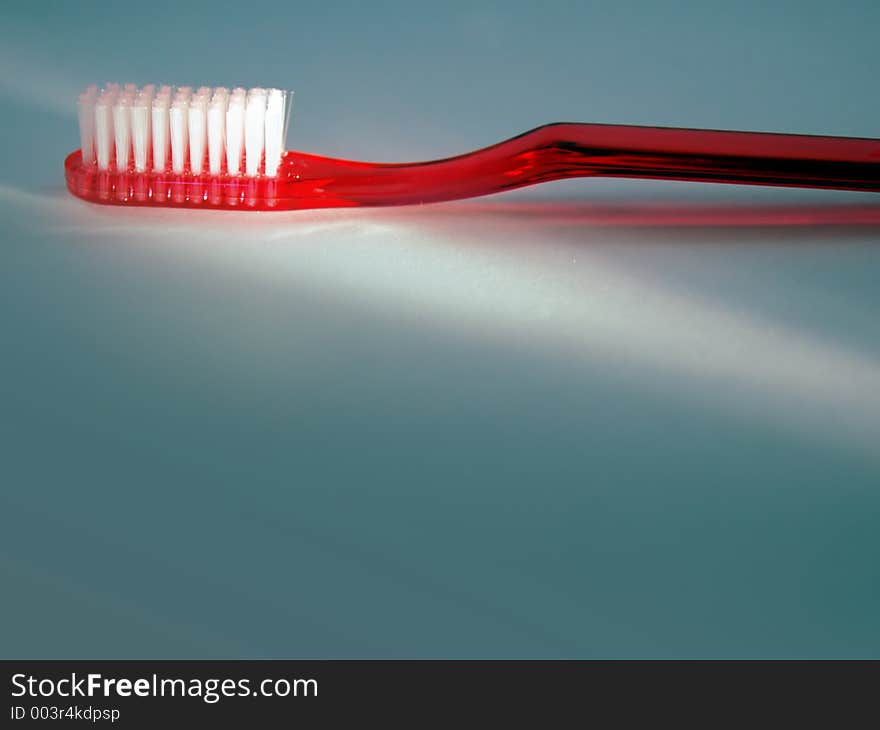 A bright red toothbrush is highlighted with room for text and titles below.