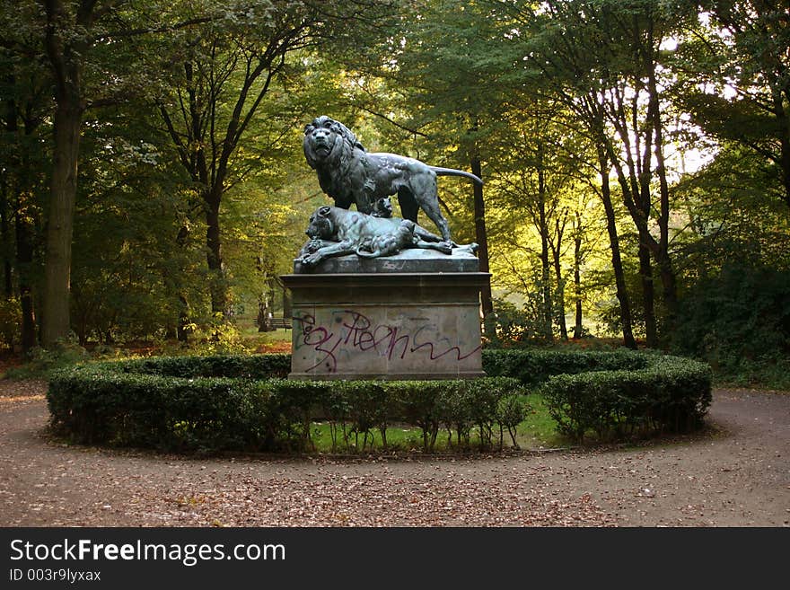 A statue with lions in a park