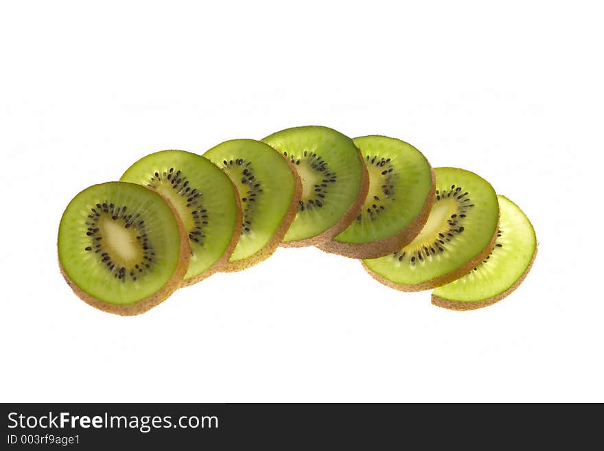 A sliced kiwi spread out across a table