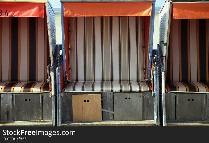 Three beach-chairs are waiting for guests. Three beach-chairs are waiting for guests.