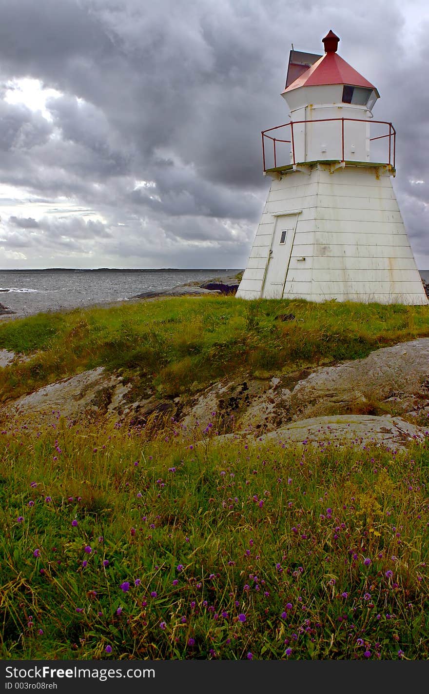 Lighthouse by the coast before a storm