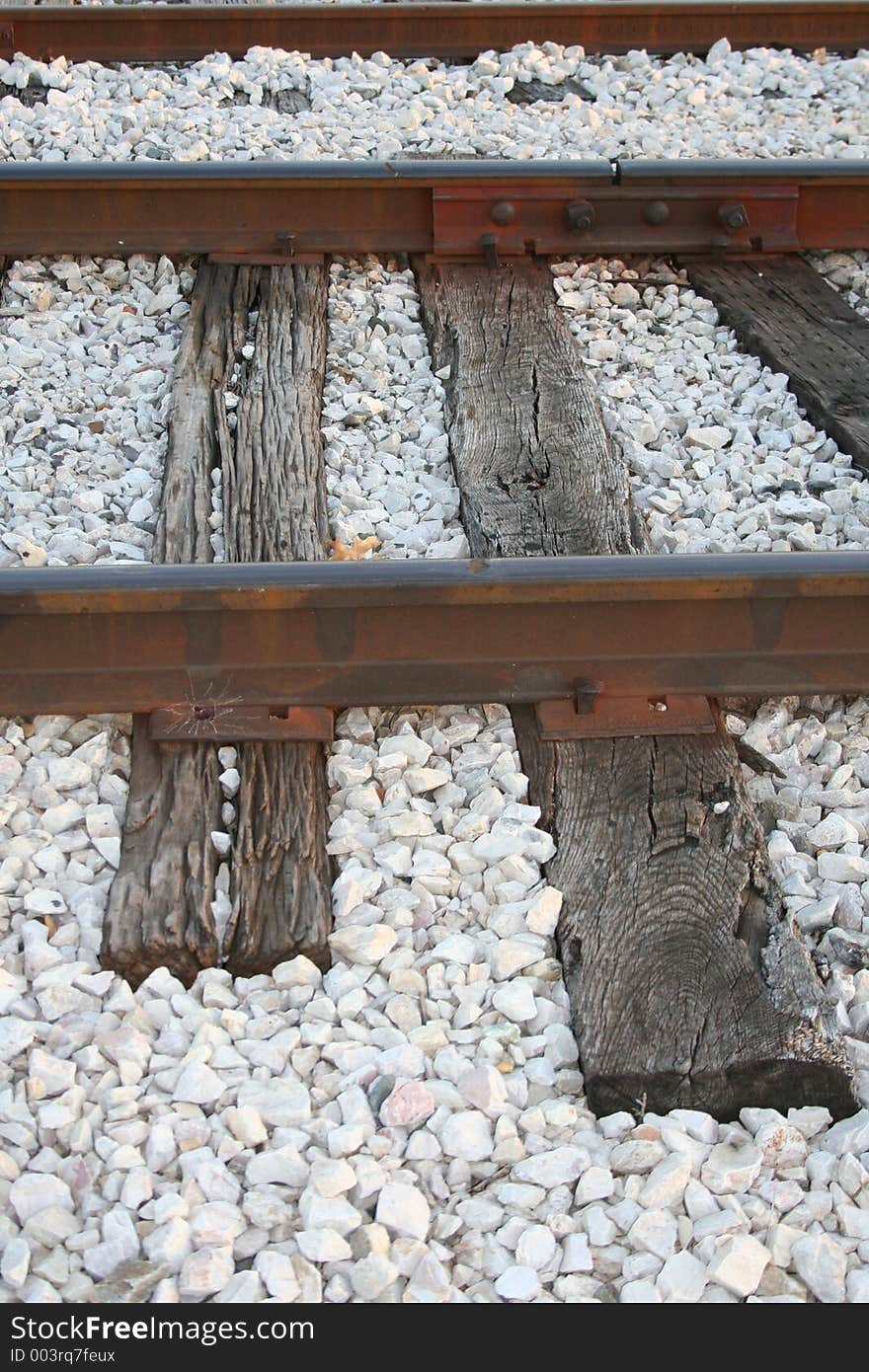 Cross-section of railroad tracks surrounded by white stones. Cross-section of railroad tracks surrounded by white stones.