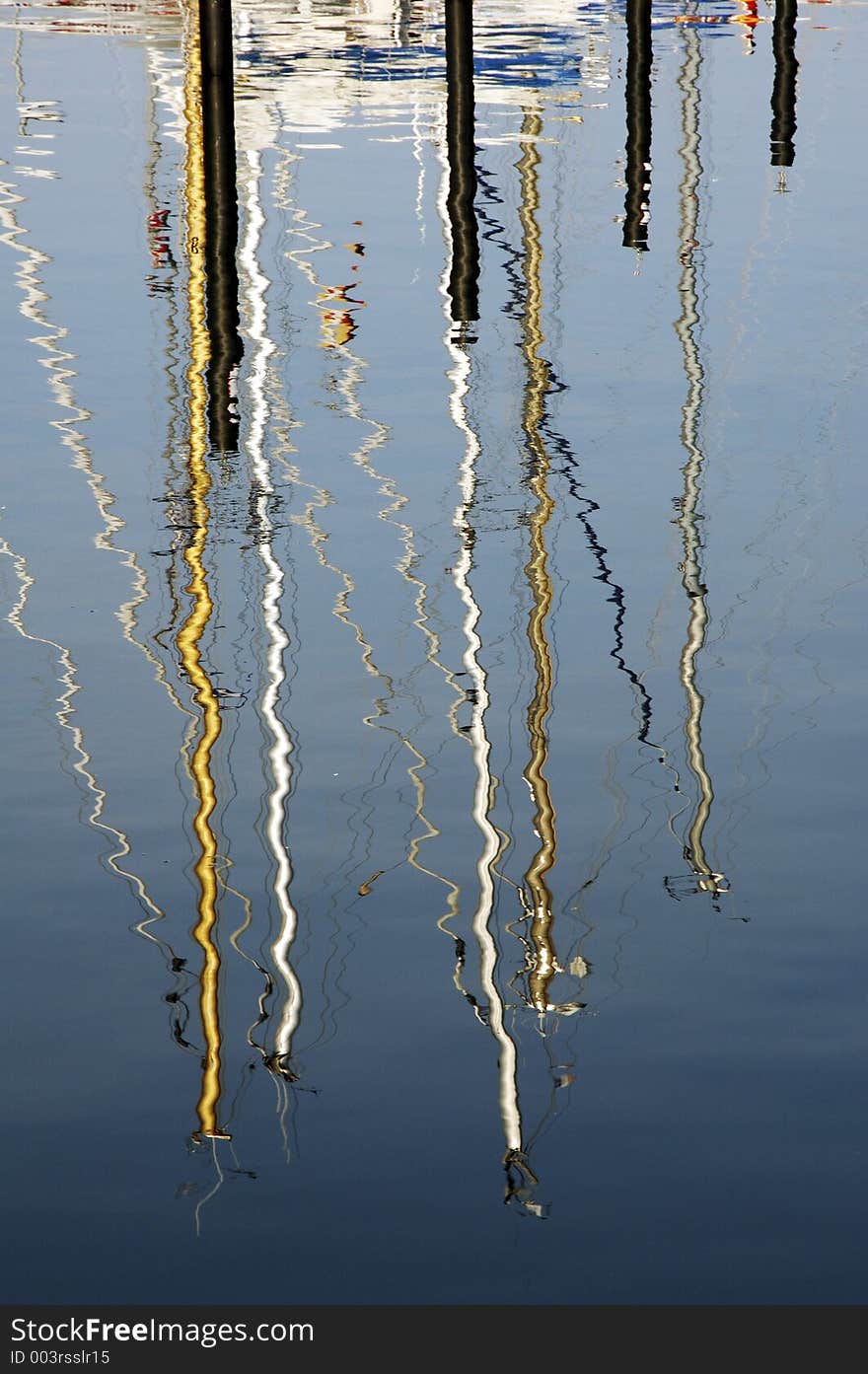 The mast of some sailboats be reflected in the water. The mast of some sailboats be reflected in the water