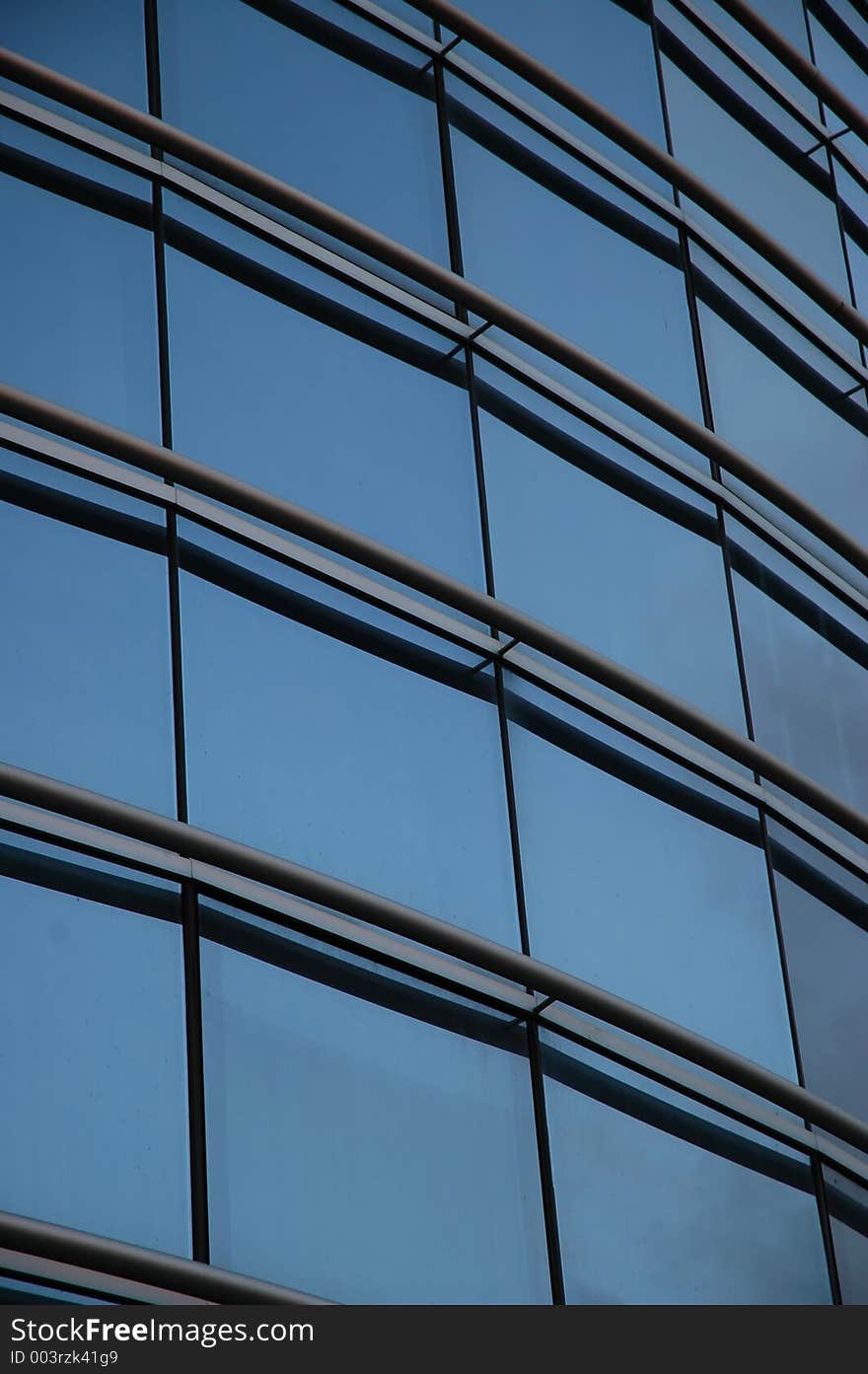 Frontal glass panels of a modern building. Frontal glass panels of a modern building.