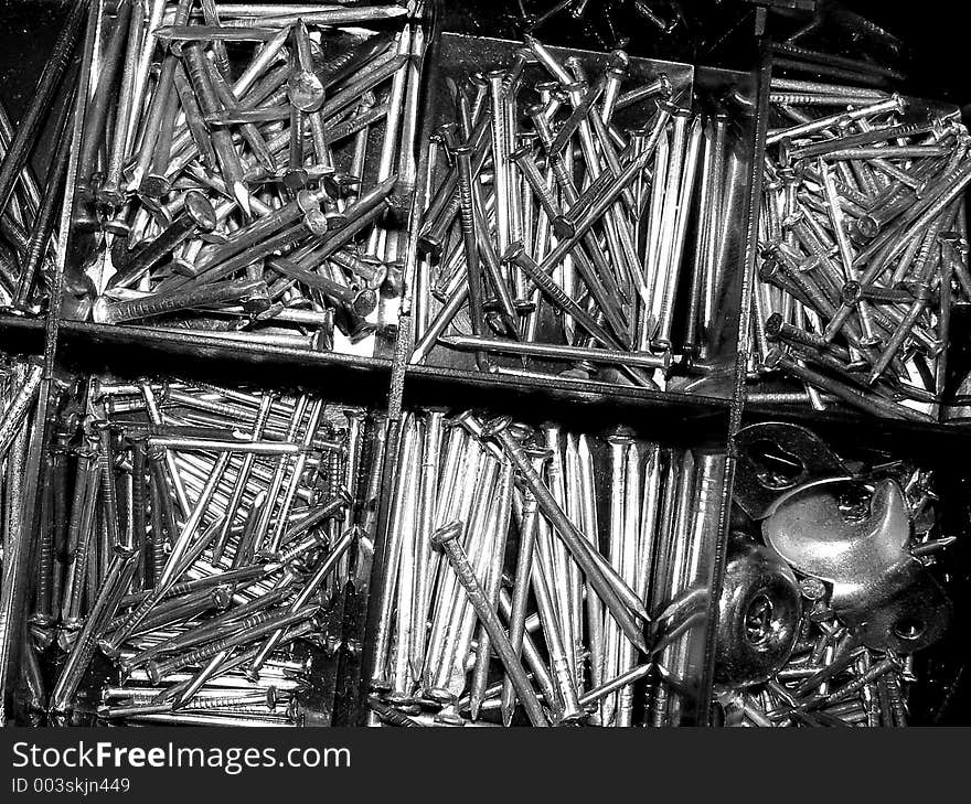 Black and white of a box of nails.