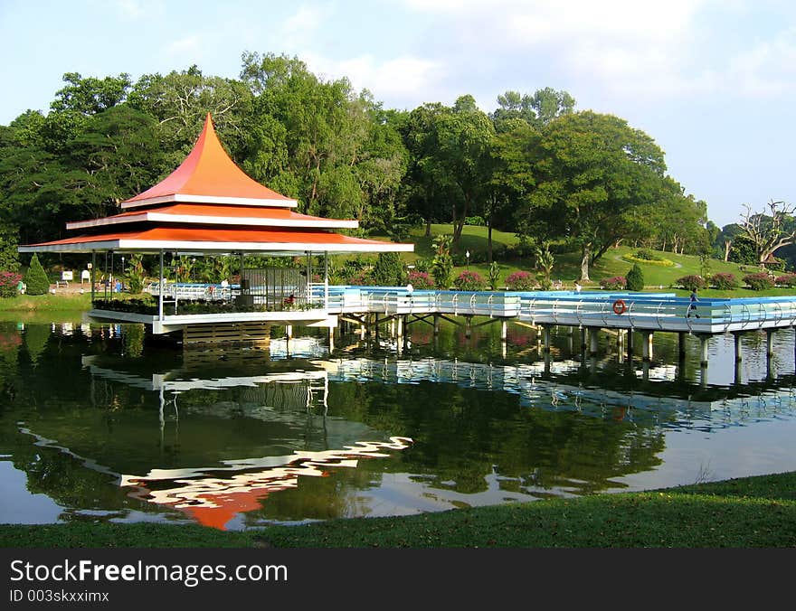 Serene and relaxing park in tropical reservoir with reflections in the water. Serene and relaxing park in tropical reservoir with reflections in the water.