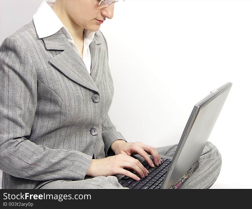 Woman with glasses sitting on a floor with laptop. Woman with glasses sitting on a floor with laptop