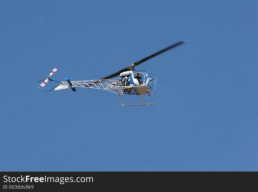 Photographer taking photos of activity on ground well flying overhead. Photographer taking photos of activity on ground well flying overhead