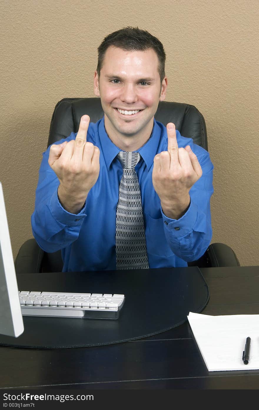 Angry employee giving the finger with both hands, carrying a fake and forced smile on his face. Angry employee giving the finger with both hands, carrying a fake and forced smile on his face