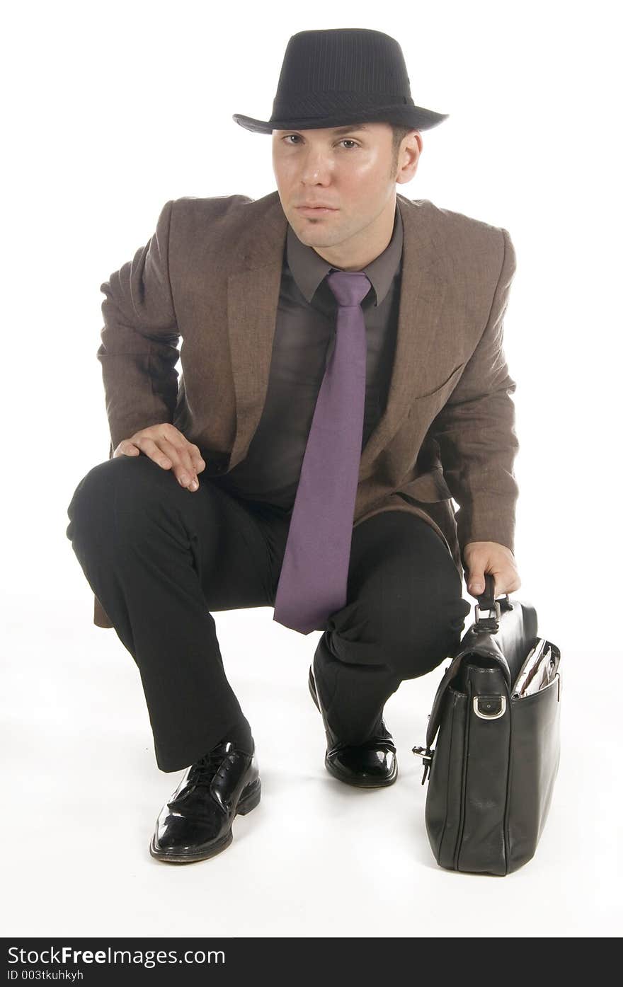 Slick businessman ready to go, grabbing his briefcase.