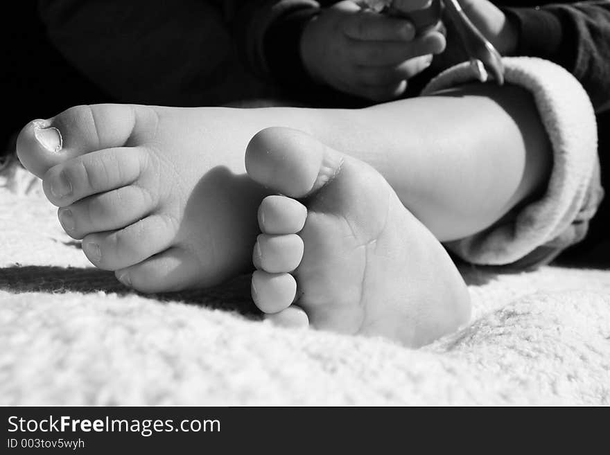 Black and white of toddlers feet crossed. Black and white of toddlers feet crossed