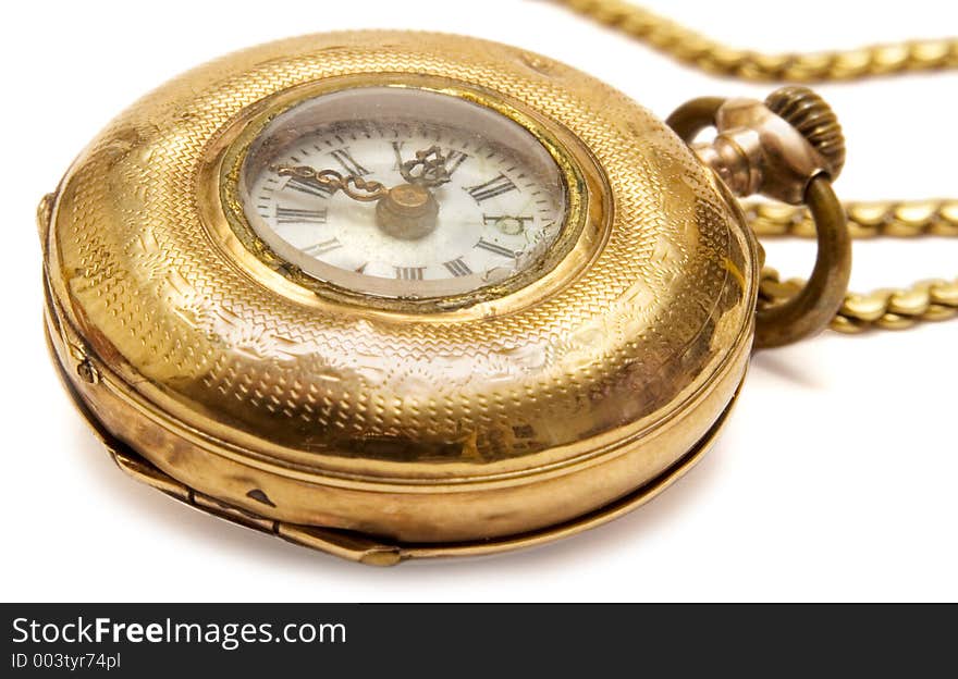 Macro shot of an aged golden pocket watch with chain. Macro shot of an aged golden pocket watch with chain.