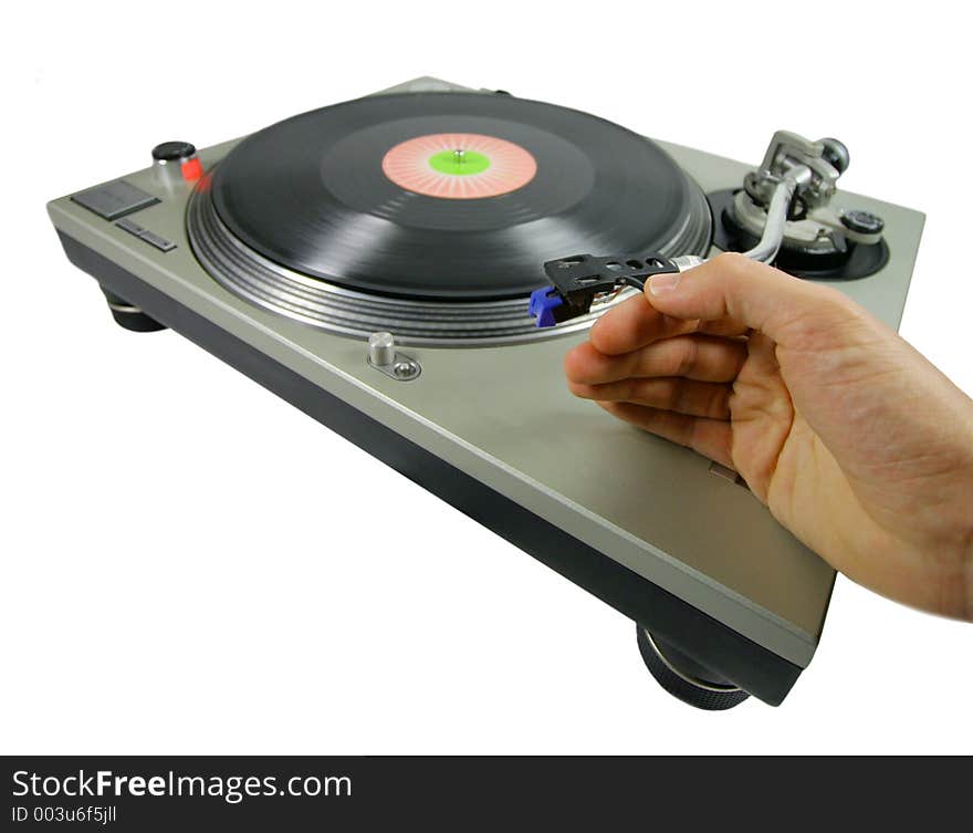 A hand putting a needle on a record. A hand putting a needle on a record