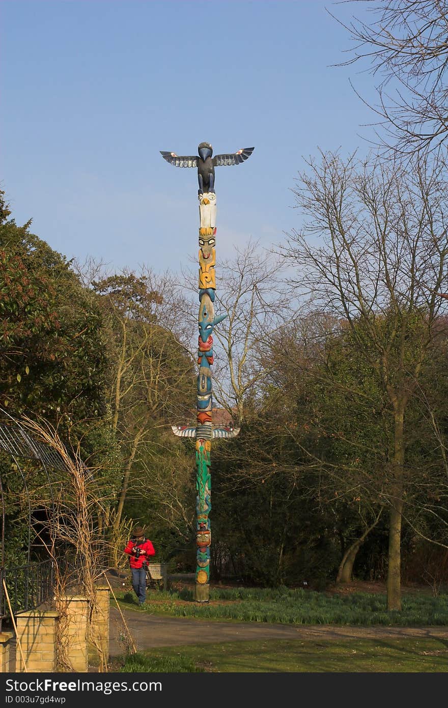 Photographer with totem pole on sunny day in park