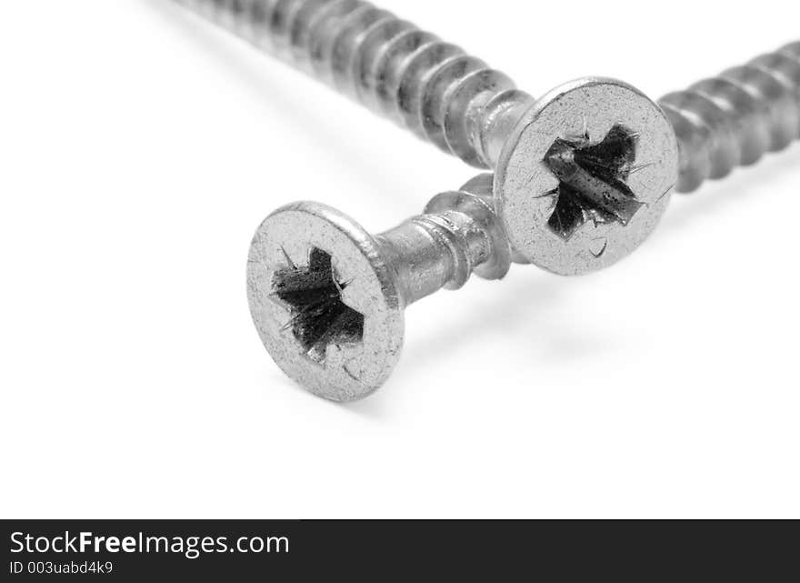 Macro shot of two crossed screws. Macro shot of two crossed screws.