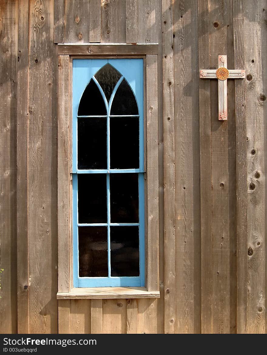 Blue church window and cross