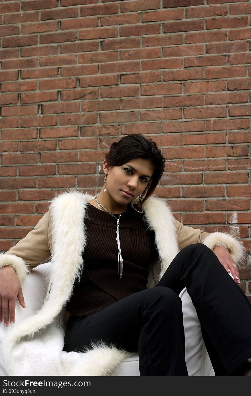 Beautiful Female Model posing in front of brick wall. Beautiful Female Model posing in front of brick wall