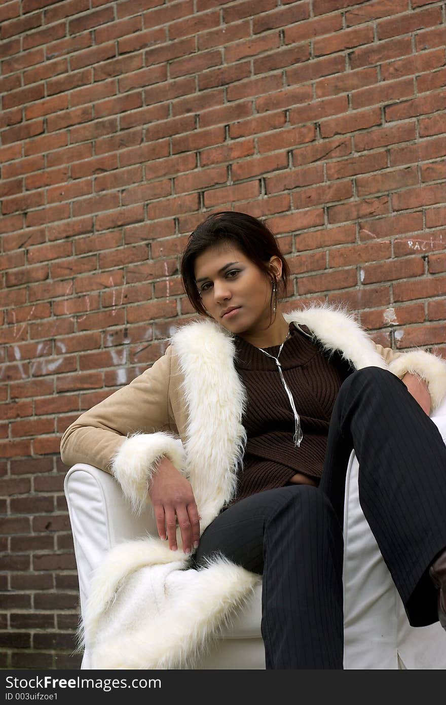 Beautiful Female Model posing in front of brick wall. Beautiful Female Model posing in front of brick wall