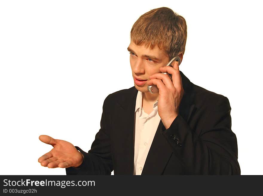 Young businessman in black suit arguing on his cell phone and gesticulating with his hand. Young businessman in black suit arguing on his cell phone and gesticulating with his hand