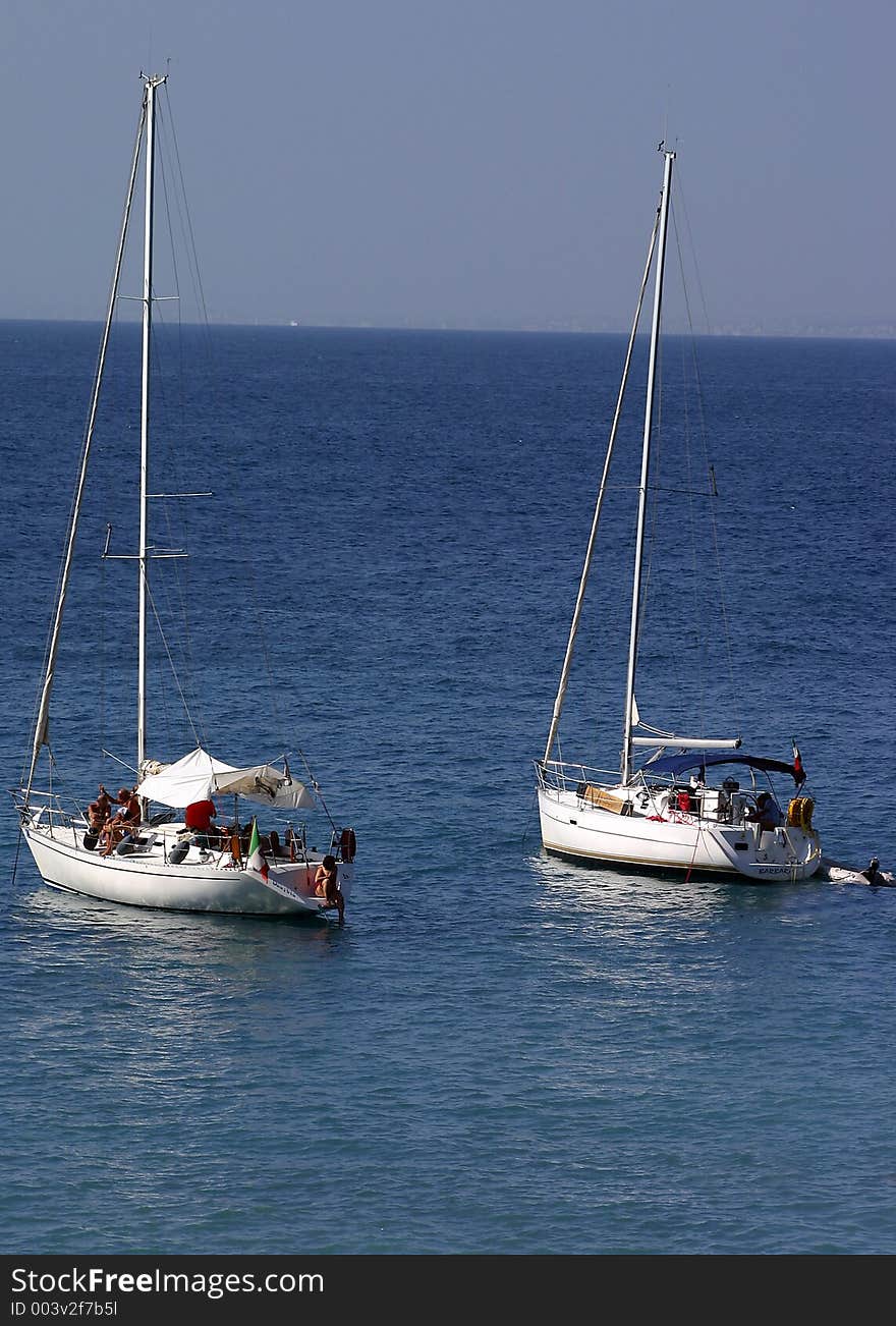 Sailboats anchored in bay